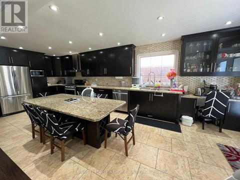 A kitchen with a table and chairs in the middle of it.