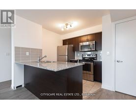 A kitchen with a granite countertop and stainless steel appliances.