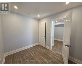A room with a white door and a white wall.