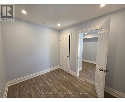 A room with a white door and a white wall.
