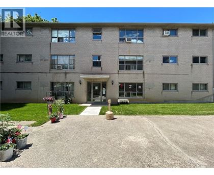A building with a lawn in front and a sign that says REALTOR.