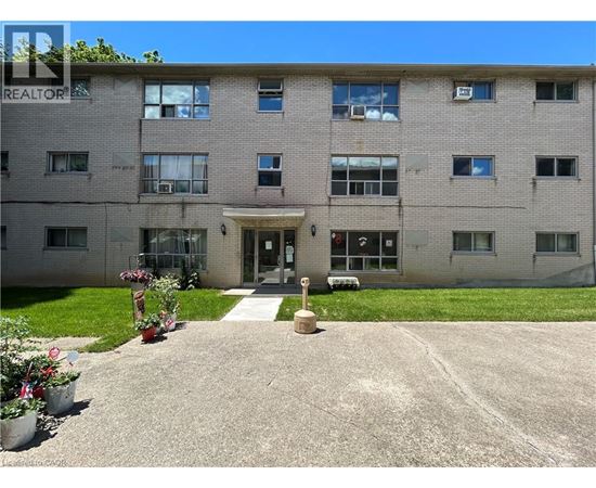 A building with a lawn in front and a sign that says REALTOR.