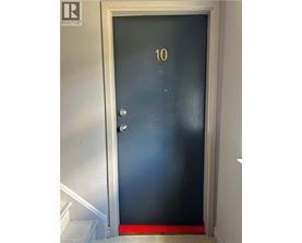 A black door with a gold number 10 on it.
