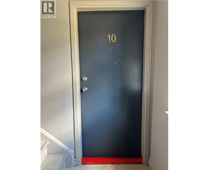 A black door with a gold number 10 on it.