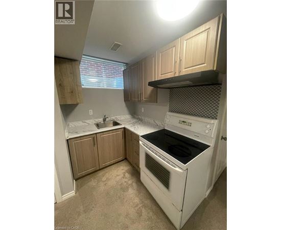 A white oven and sink in a kitchen.