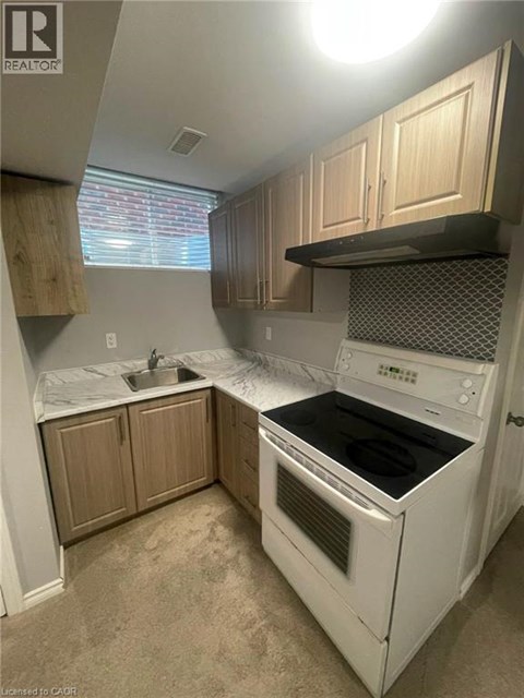 A white oven and sink in a kitchen.