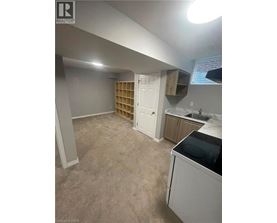 A kitchen area with a washing machine and a cabinet.