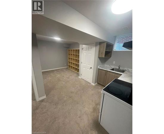A kitchen area with a washing machine and a cabinet.