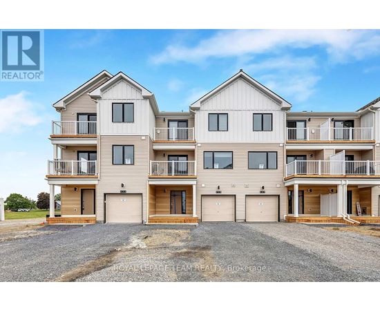 A large, modern two-story residential building with multiple balconies and garage doors.