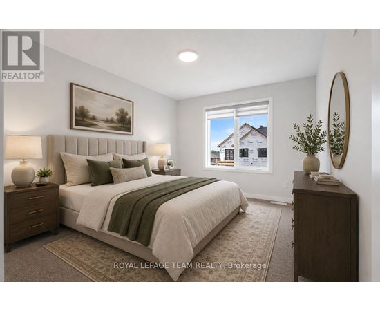 A bedroom with a large bed, a nightstand, and a framed picture on the wall.