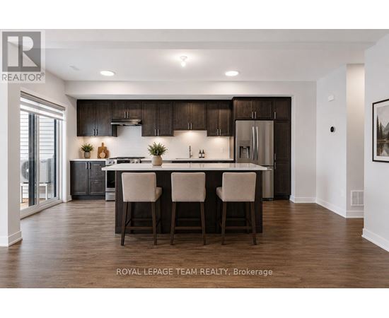 A modern kitchen with dark wood cabinets and a center island.
