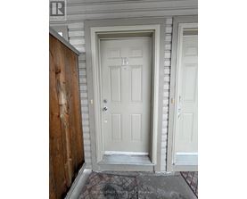 A white door with a letter B on it.
