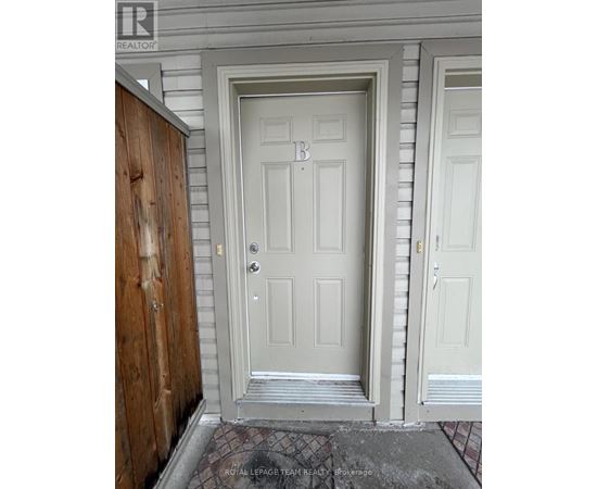 A white door with a letter B on it.