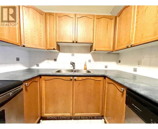 A kitchen with wooden cabinets and a sink.