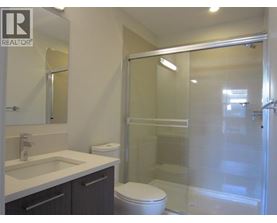 A bathroom with a toilet, sink, and shower.