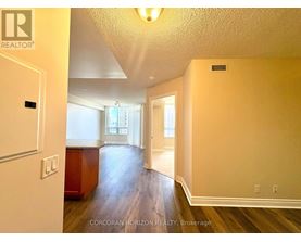 A room with a wooden floor and white walls.