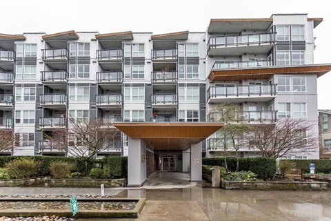 A large white building with a brown overhang in front.