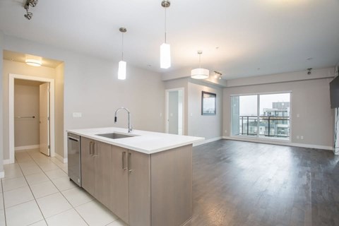A kitchen with a sink and cabinets is shown.