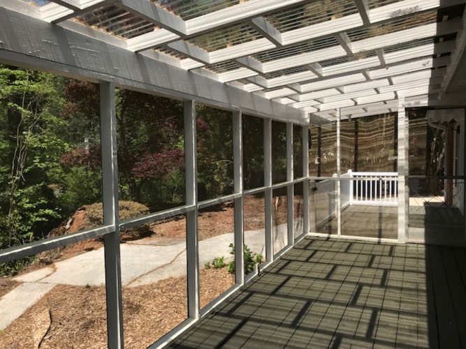 A long covered walkway with a metal railing on the left side.