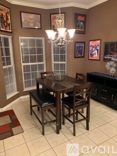 A dining room with a wooden table and chairs.