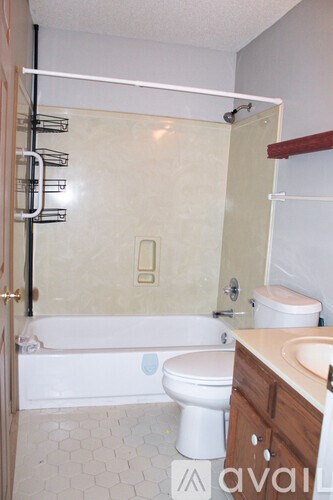 A bathroom with a toilet, sink, and bathtub.