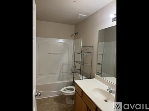 A bathroom with a toilet, sink, and shower.