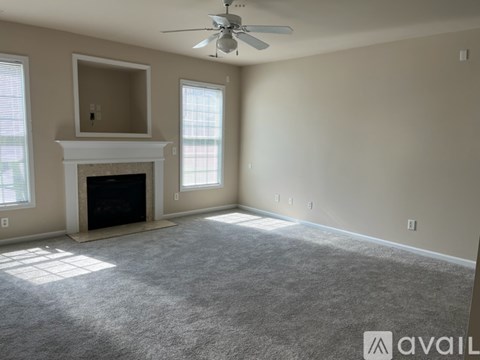 A room with a fireplace and a ceiling fan.