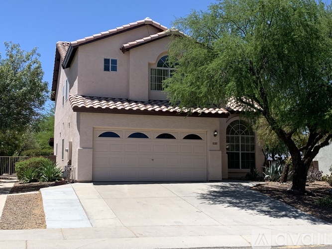 A house with a white garage door and a brown roof.