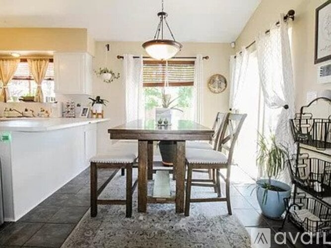 A dining area with a table and chairs.