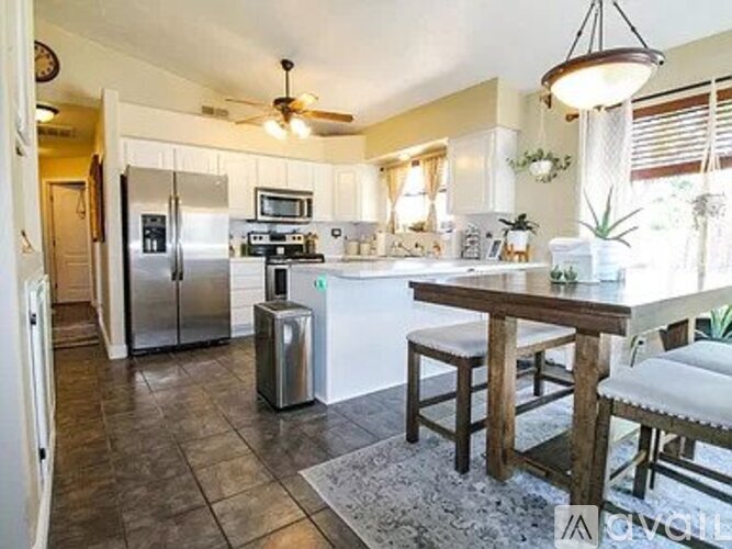 A kitchen with a refrigerator, stove, and oven.
