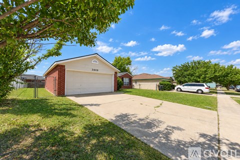A house with a brown roof and a white garage door is for sale.