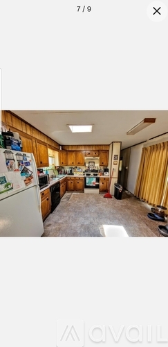 A kitchen with wooden cabinets and a white refrigerator.