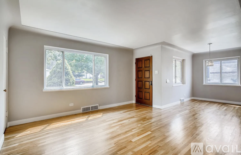 A room with wooden floors and a large window.