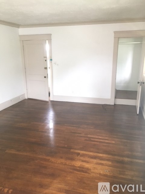 A room with wooden floors and white walls.