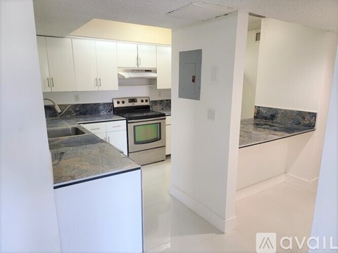 A kitchen with a stove top oven and a counter top.
