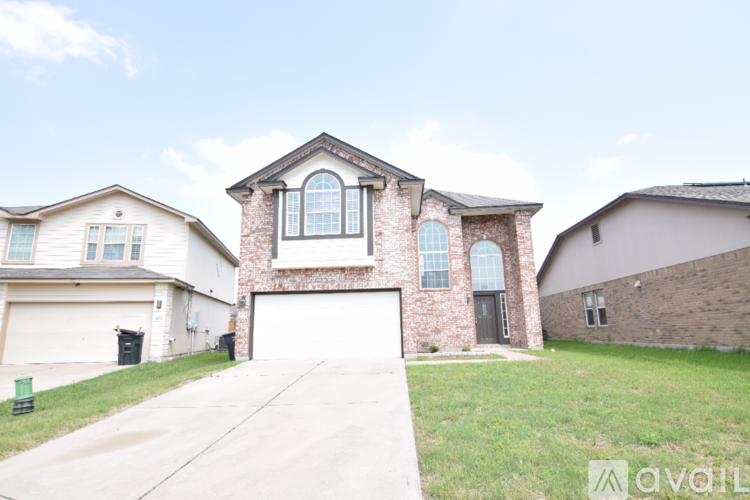 A house with a brick facade and a large garage door.