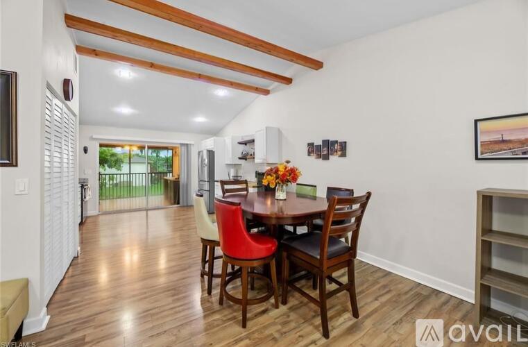 A dining room with a wooden table and chairs.