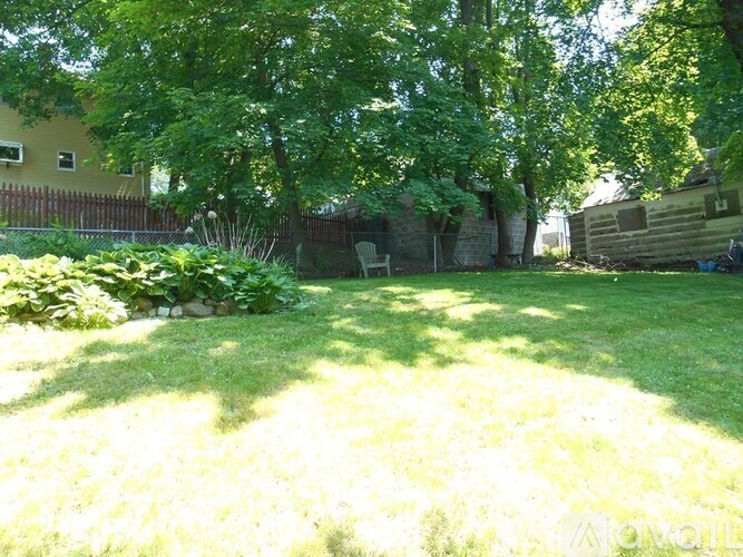 A backyard with a lawn and trees.