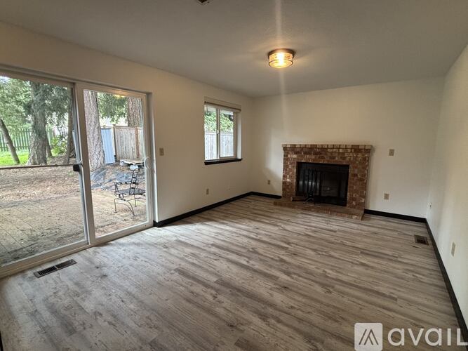 A living room with a fireplace and sliding glass doors.