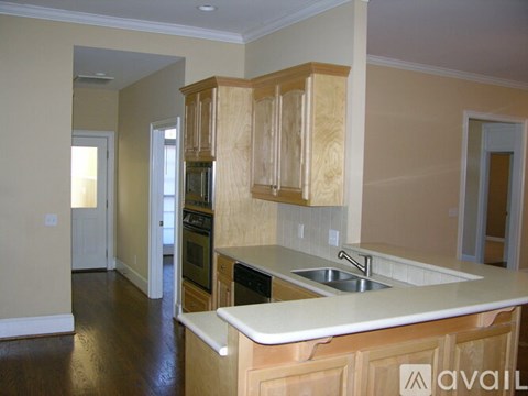 A kitchen with wooden cabinets and a white countertop.