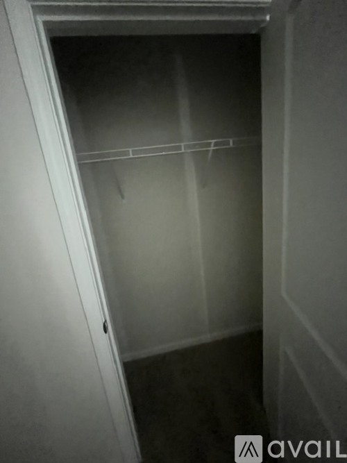 A small, empty closet with a single hanger rod.
