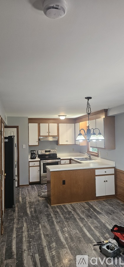 A kitchen with a wooden island and white cabinets.