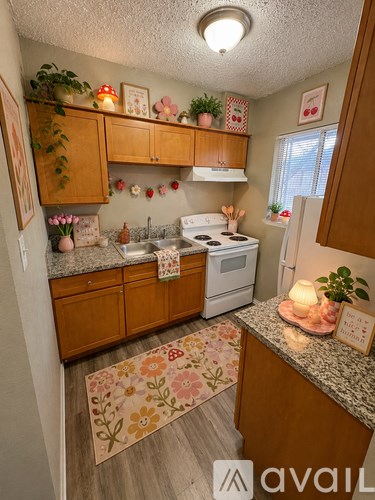 A kitchen with wooden cabinets and a granite countertop.