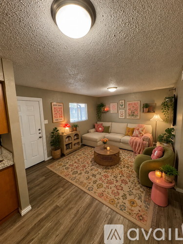A living room with a couch, a coffee table, and a rug.