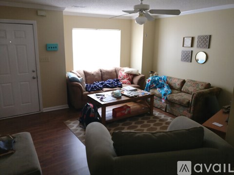 A living room with a brown couch and a coffee table.