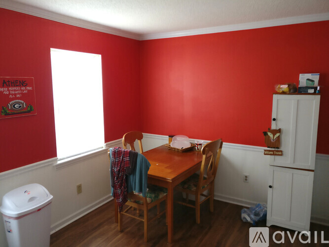 A dining room with red walls and a wooden table.