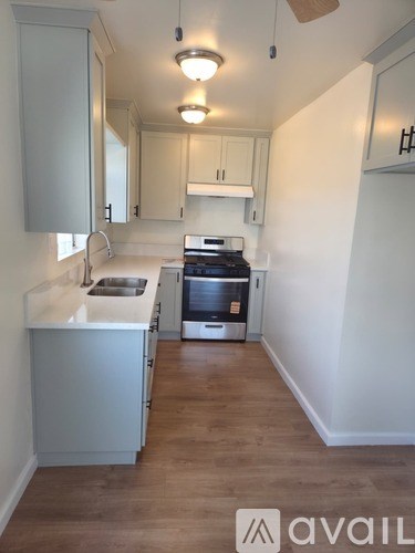 A kitchen with a stove and a sink.