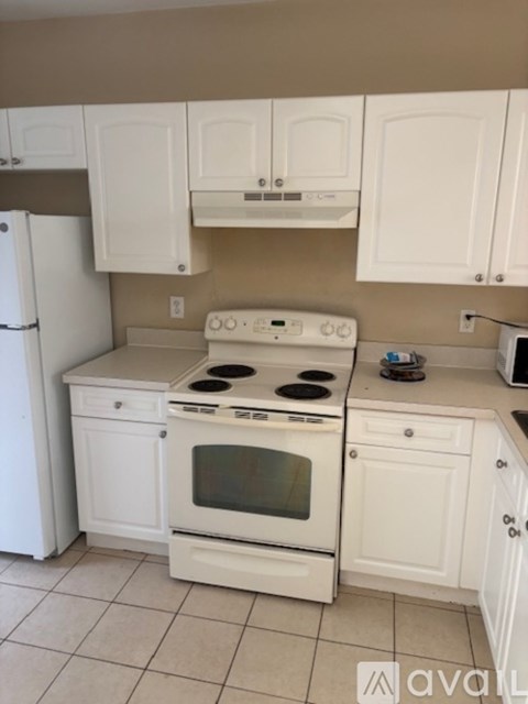 A white kitchen with a stove and oven.
