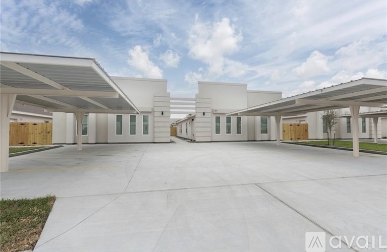 A modern building with a spacious courtyard in front.