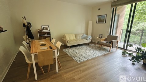 A living room with a dining table and chairs.